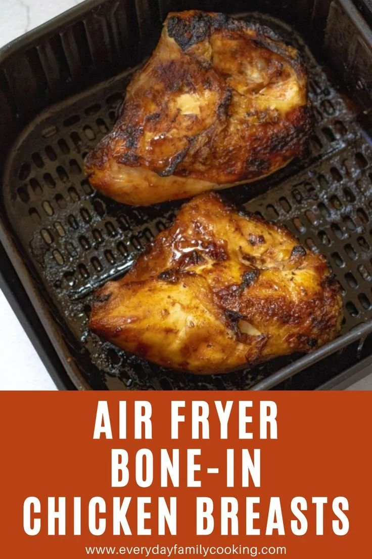 Air Fried bone-in chicken breasts served on a plate with herbs