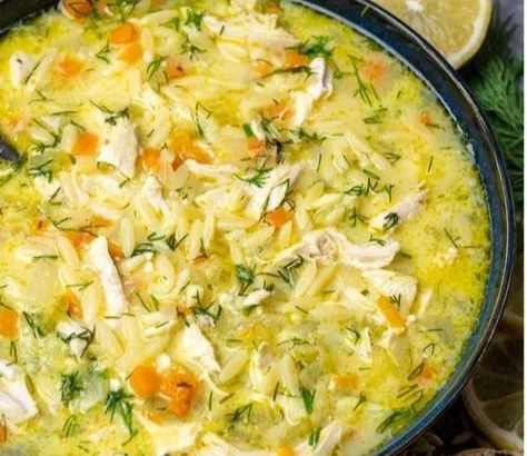 Bowl of Greek Lemon Chicken Soup (Avgolemono) garnished with parsley.