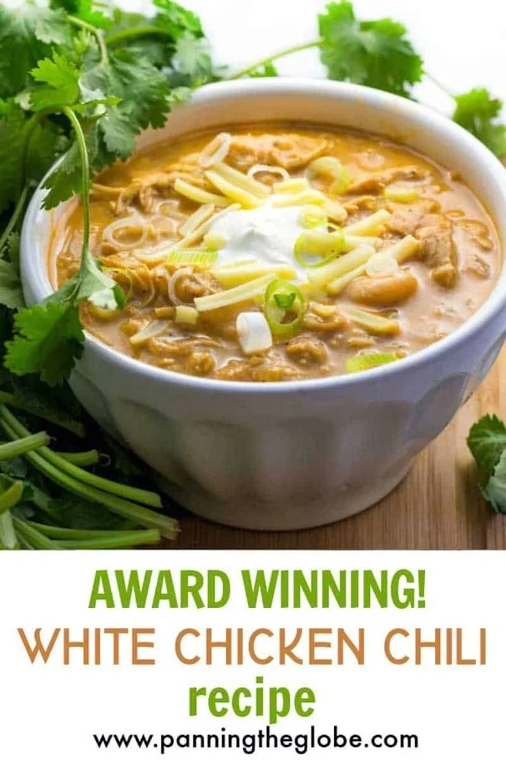 Bowl of award winning white chicken chili topped with cilantro and lime.