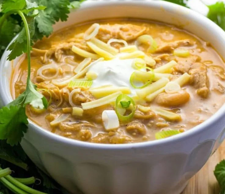 Delicious bowl of award-winning white chicken chili topped with cilantro and cheese