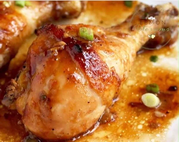 Baked chicken drumsticks marinated in honey and soy sauce on a serving platter