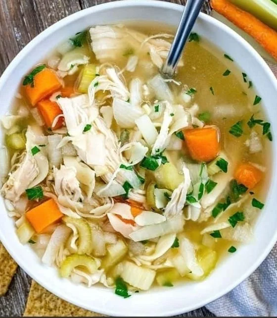 Bowl of homemade crockpot chicken noodle soup with vegetables and noodles
