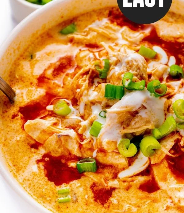 Bowl of Buffalo Chicken Soup topped with green onions and served with bread