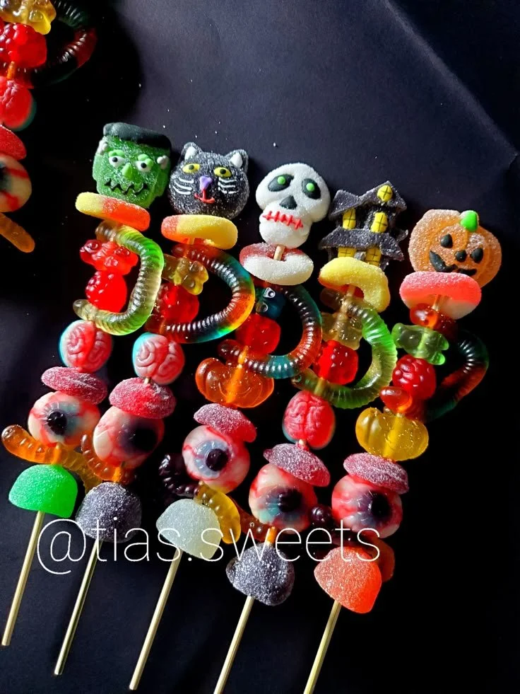 Colorful candy kabobs with various sweets and treats on skewers