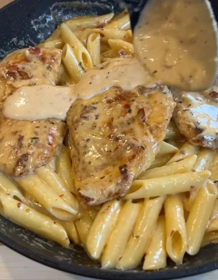 Delicious cheesy chicken pasta in a creamy sauce topped with herbs