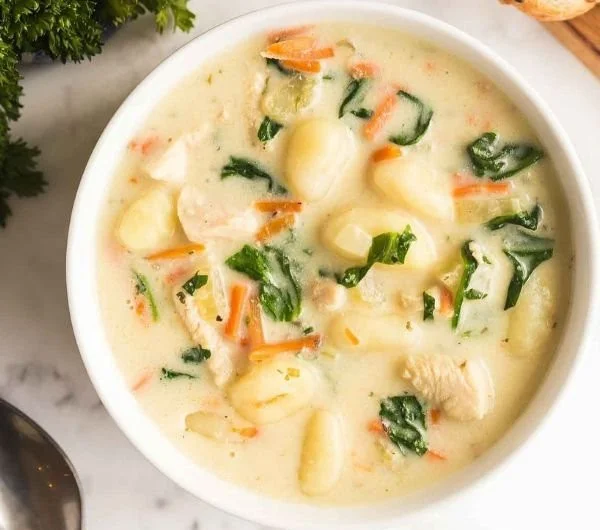 Bowl of Chicken Gnocchi Soup with vegetables and herbs, garnished for a tasty finish