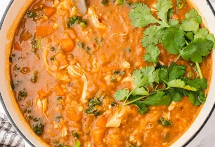 Bowl of Chicken Lentil Soup topped with fresh herbs