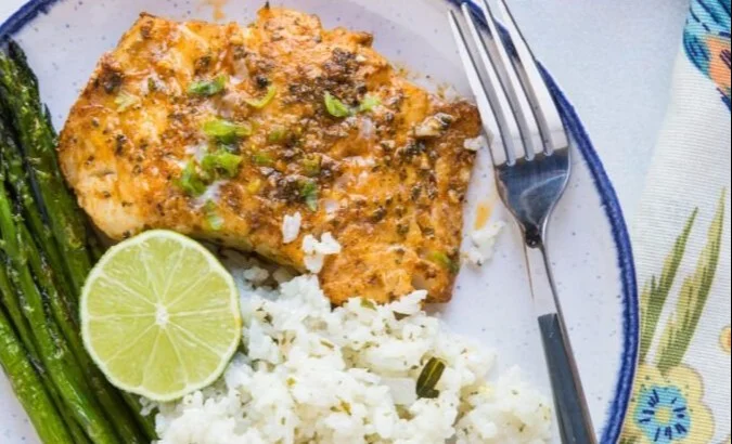 Chili Lime Baked Cod garnished with fresh limes, ready to serve.