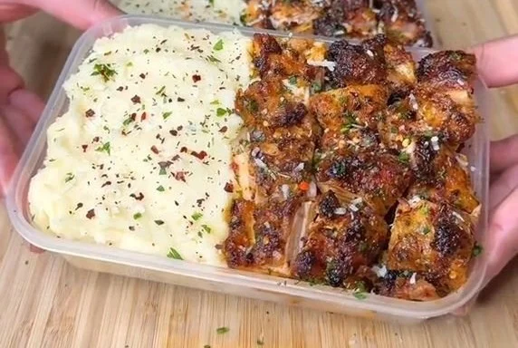 Creamy garlic herb Cajun chicken dish served with fresh herbs and spices.