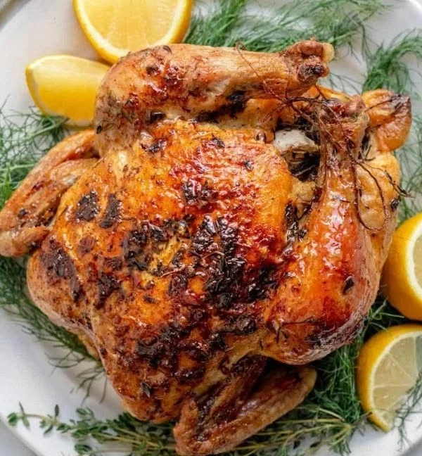 Garlic and herb whole roasted chicken served on a platter