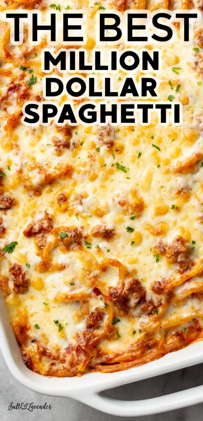 A close-up of a plated dish of Million Dollar Spaghetti, topped with cheese and herbs.