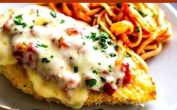 Oven baked chicken parmesan with melted cheese and marinara sauce