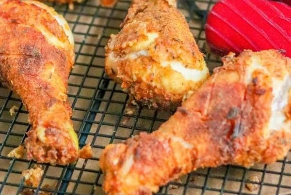 Golden-brown oven fried chicken served with side dishes
