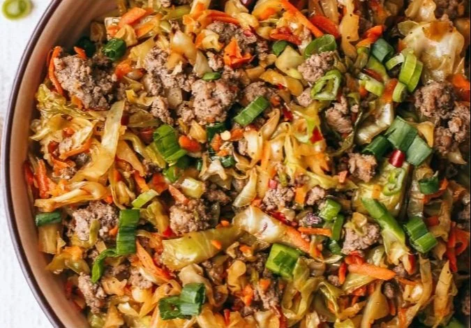 Paleo egg roll in a bowl served in a dish with fresh vegetables