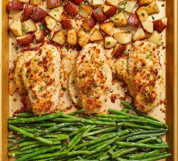 Delicious Parmesan Crusted Chicken served with roasted vegetables on a sheet pan.