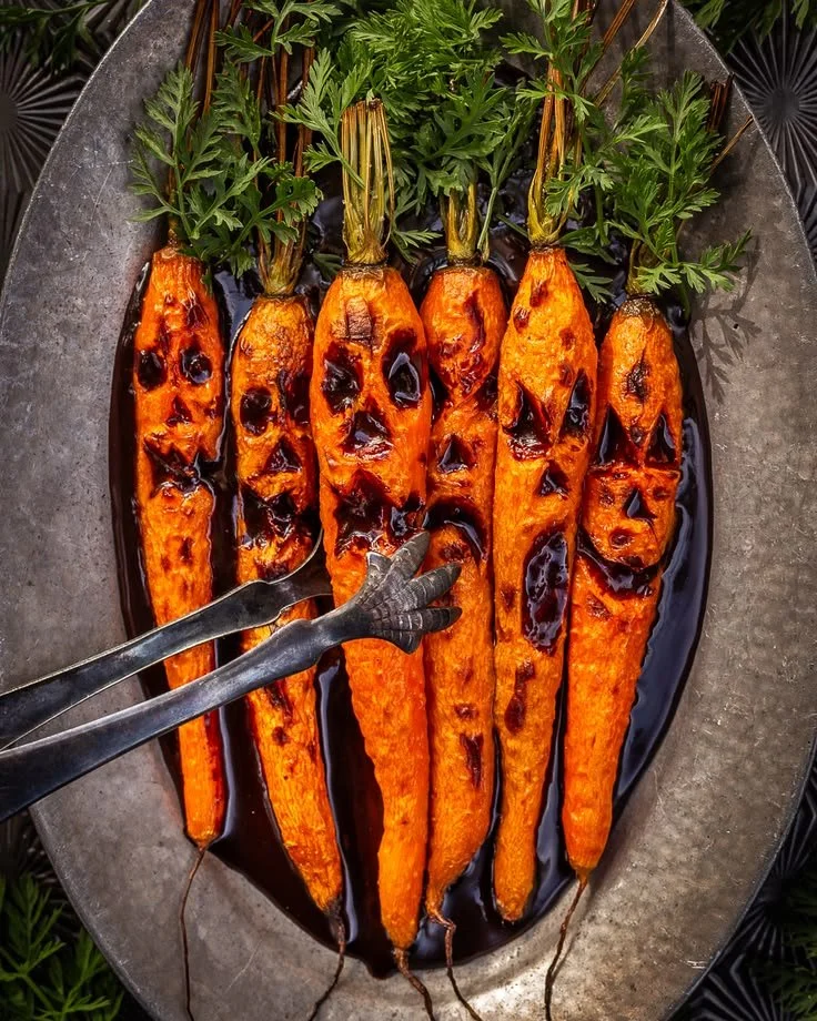 Plate of roasted carrots topped with chocolate balsamic sauce