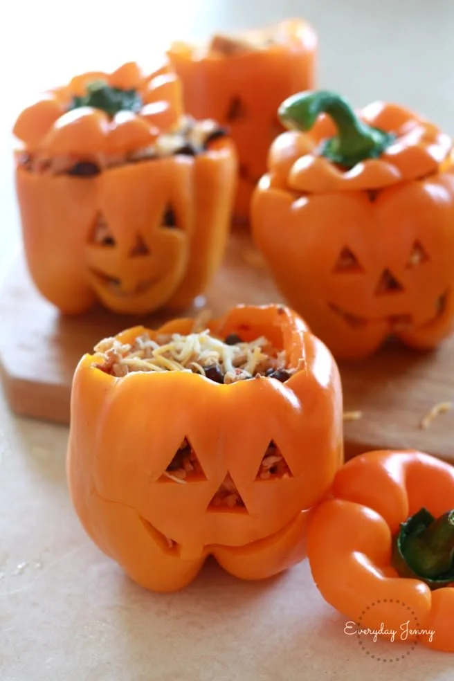 Halloween-style stuffed peppers filled with shredded chicken and rice.