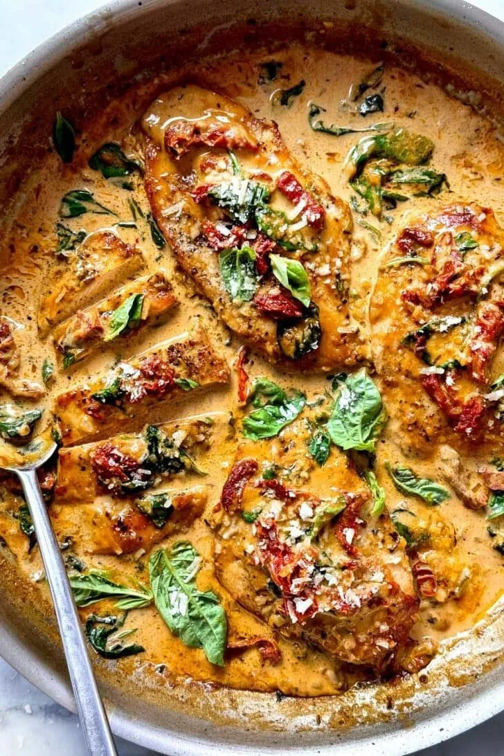Skillet chicken with sun-dried tomato cream sauce, garnished and plated.
