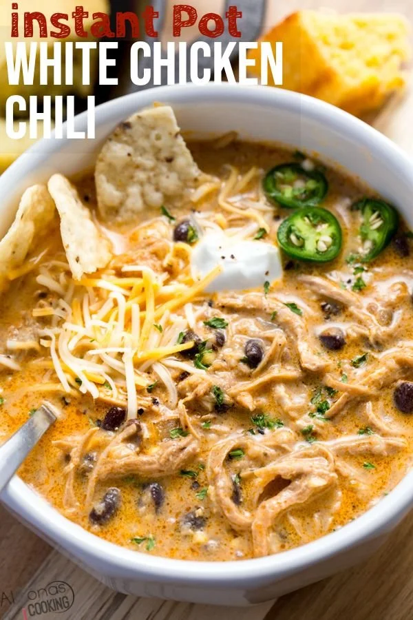 Bowl of white chicken chili topped with cilantro and lime