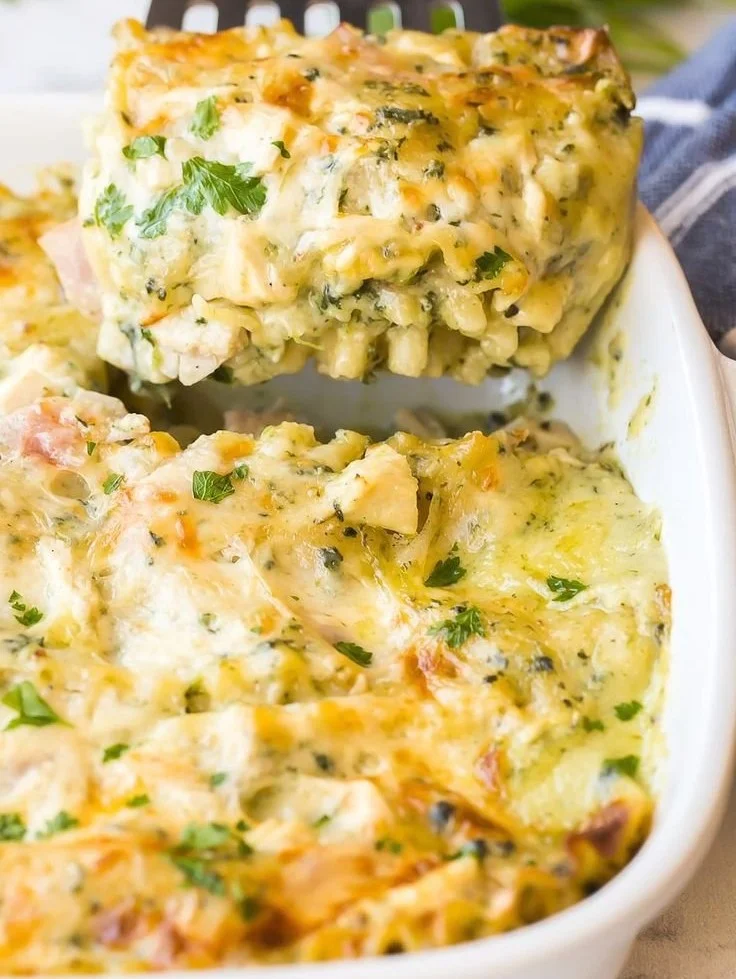 White chicken lasagna with ham and spinach served on a plate