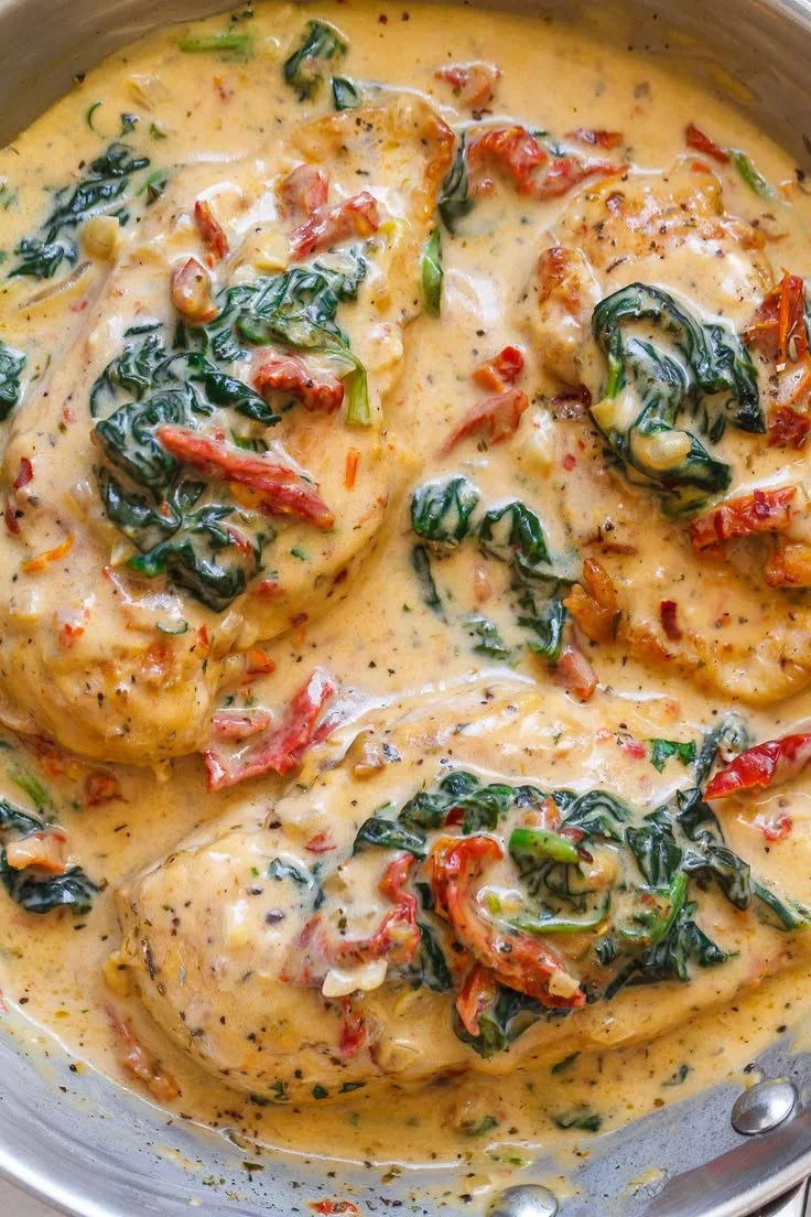 Creamy Parmesan Chicken with Spinach and Tomato served on a plate