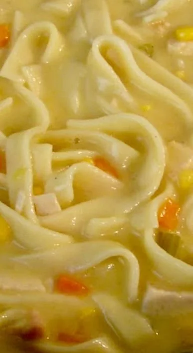 Bowl of Crockpot Creamy Chicken Noodle Soup with vegetables and noodles