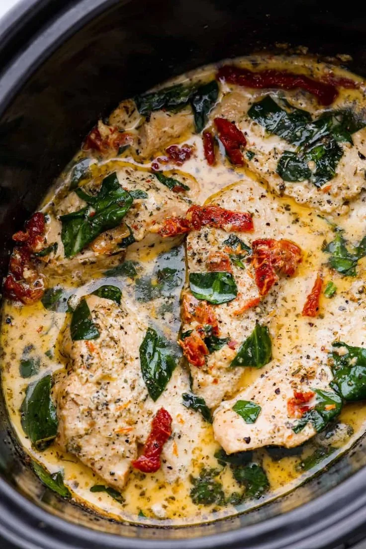 Crockpot Tuscan chicken with Parmesan and sun-dried tomato sauce in a slow cooker