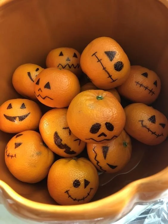 Cute Halloween snacks with orange faces for kids parties and celebrations