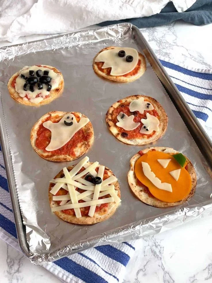 Delicious mini Halloween pizzas decorated for a spooky celebration.
