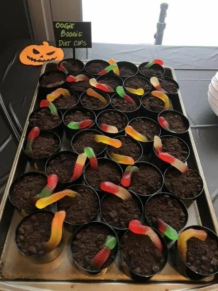 Elegant Halloween party setup with decorated dishes and spooky decorations