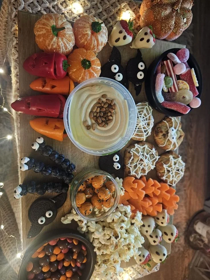 A creative Halloween board showcasing decorations and themed ideas for Halloween.