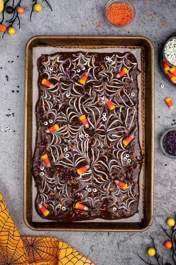 A delicious Halloween chocolate bark topped with festive decorations.