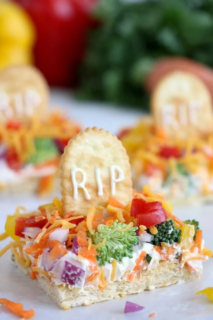 Spooky Halloween veggie pizza with graveyard decorations