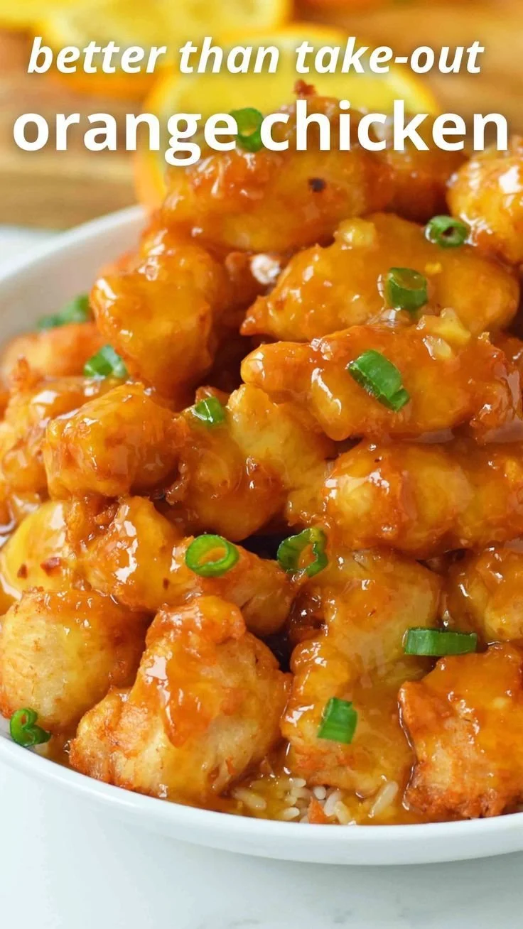 Delicious homemade orange chicken served in a bowl with rice and vegetables