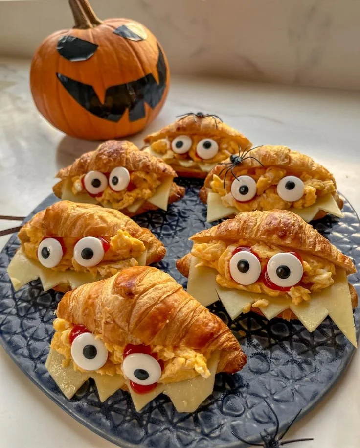 A close-up of a delicious Monster Croissant filled with chocolate and colorful sprinkles