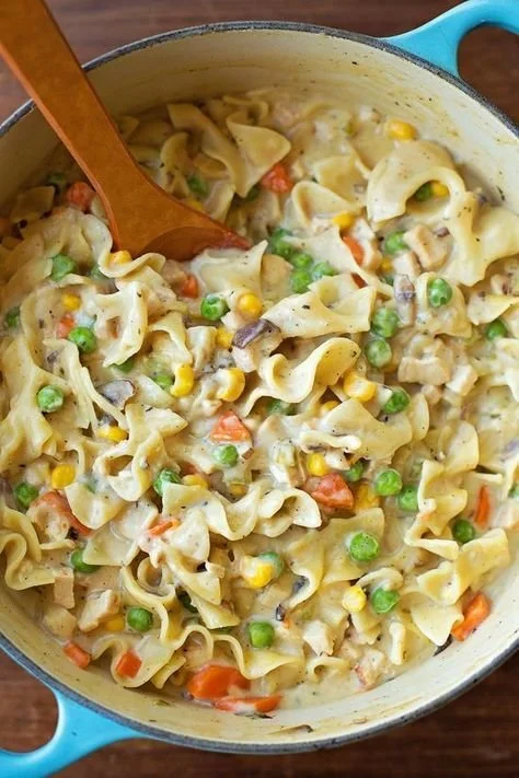 Creamy chicken pot pie noodles served in a bowl for a comforting dinner.