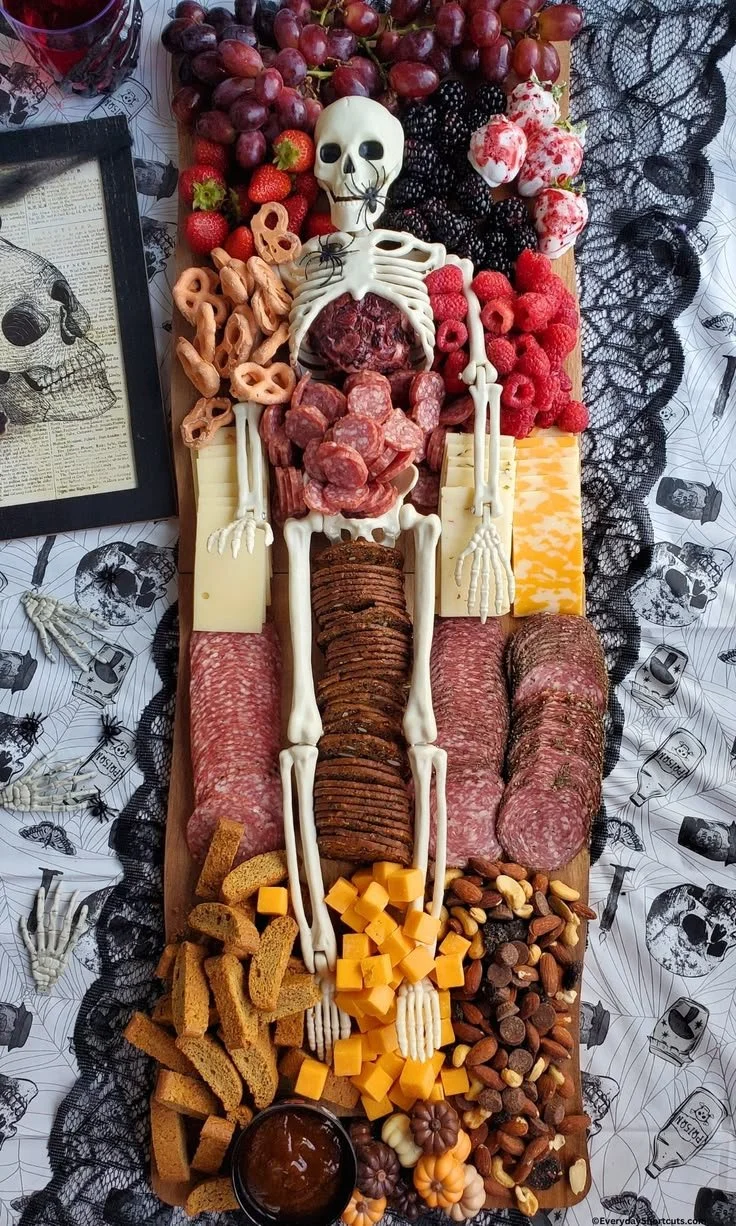 Skeleton charcuterie board featuring themed snacks for Halloween celebrations