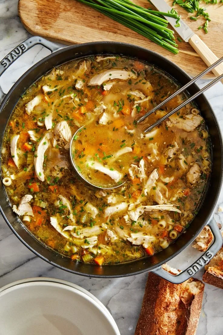Southern Style Chicken and Dumplings dish in a bowl with herbs