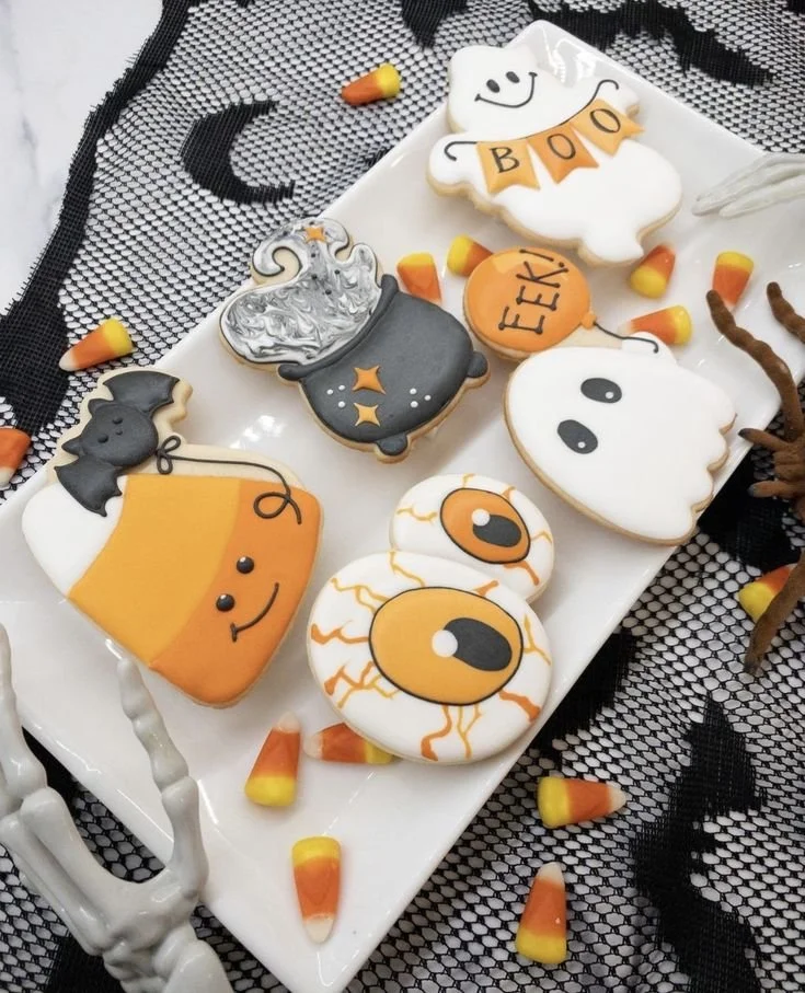 Decorated spooky Halloween cookies with royal icing designs for a festive celebration.