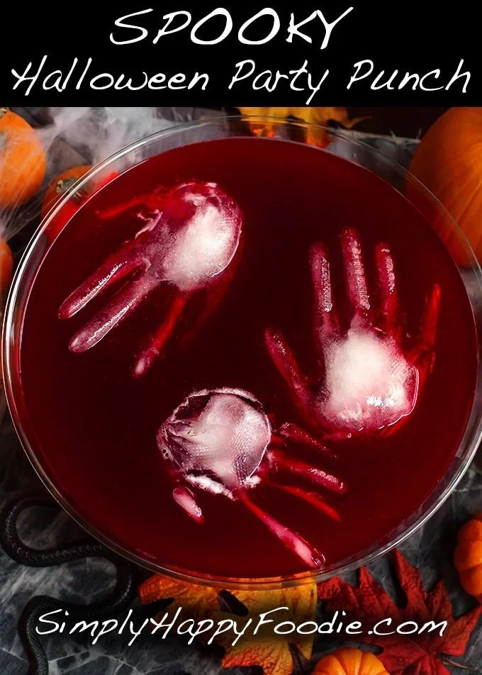A colorful Spooky Halloween Party Punch in a decorative bowl with spooky garnishes.
