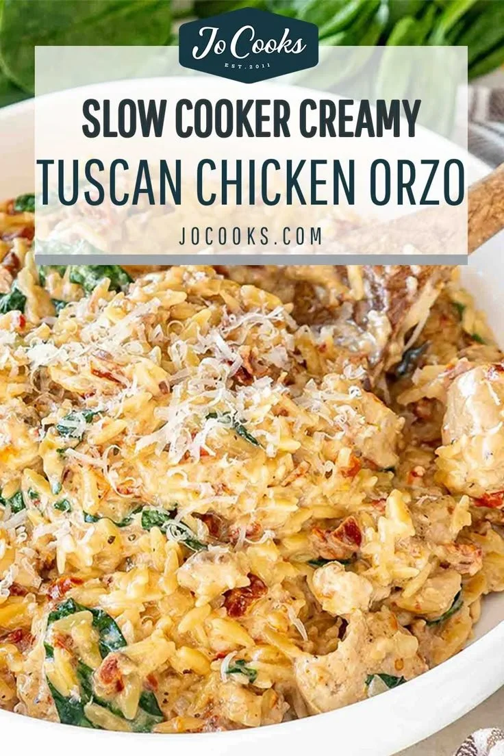 Creamy Tuscan chicken orzo prepared in a slow cooker, garnished with herbs.
